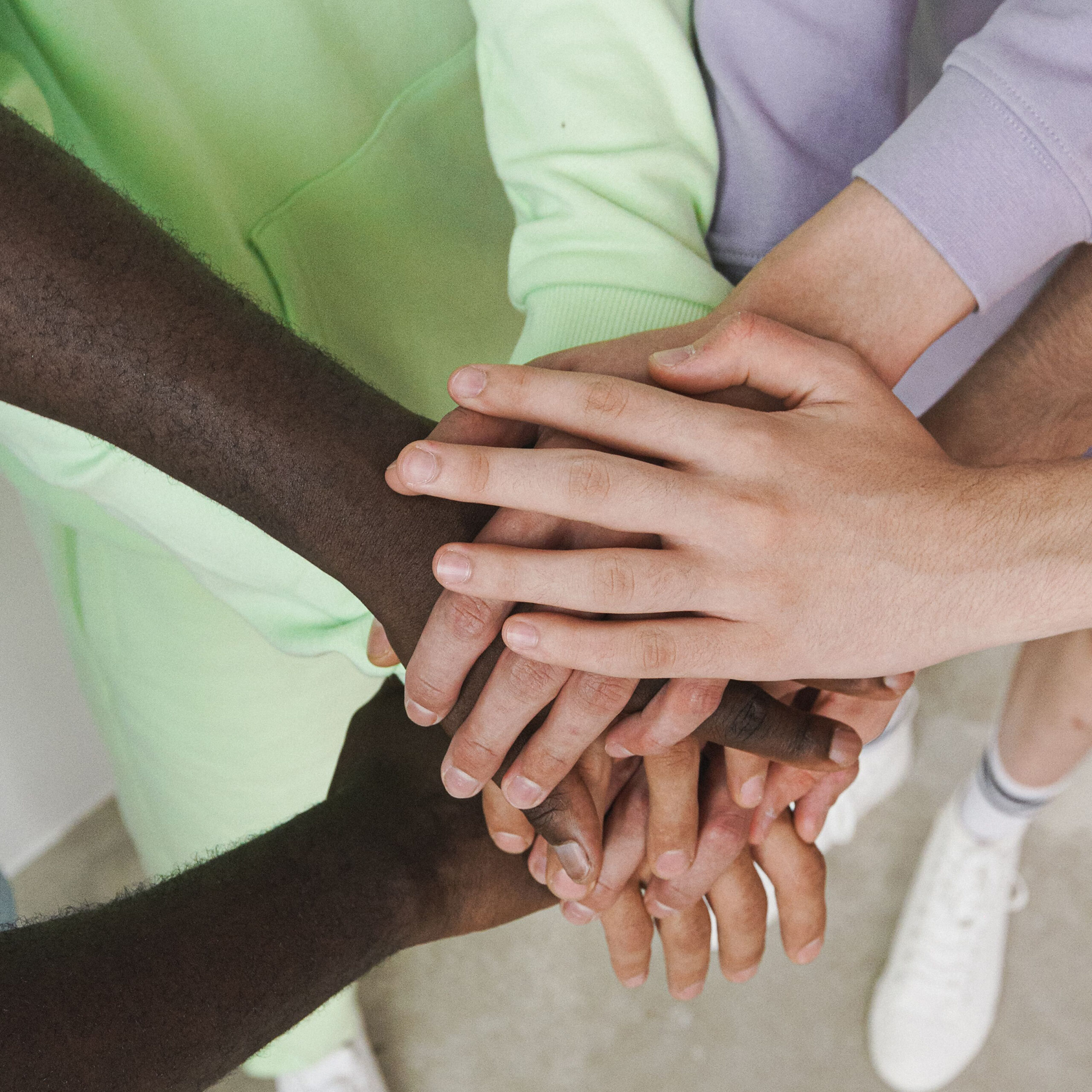 Hands on top of each other showing encouragement.